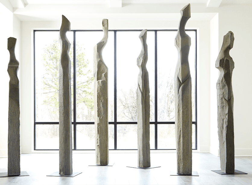 The Phillips Collection Colossal Gray Cast Woman Sculpture A is an abstracted female form that is very tall in a dark gray finish.